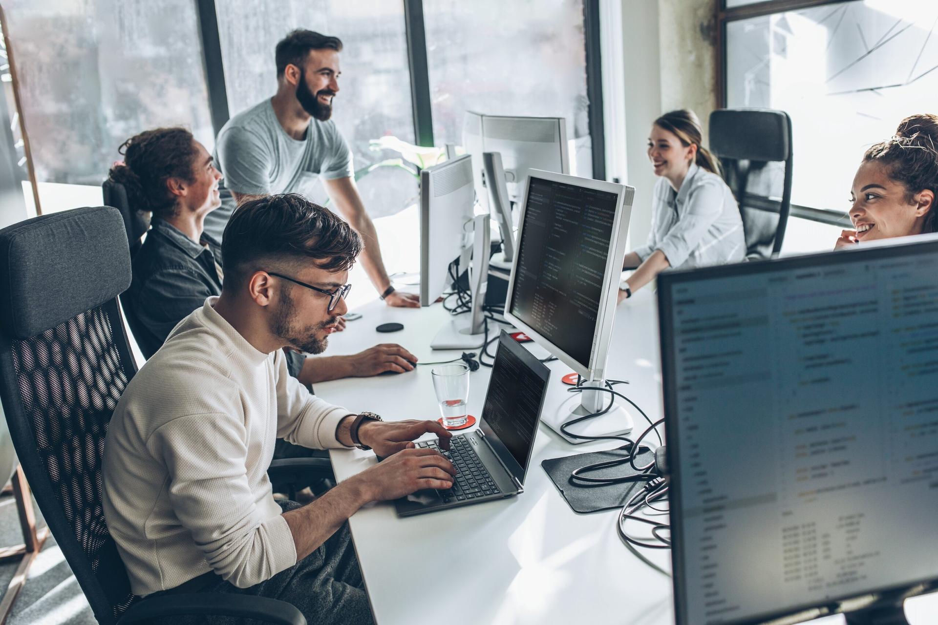 A group of developers working on laptops